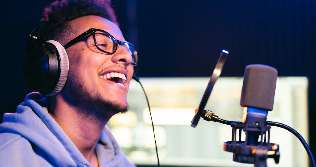 How to monetize a podcast: image of a podcaster laughing while recording