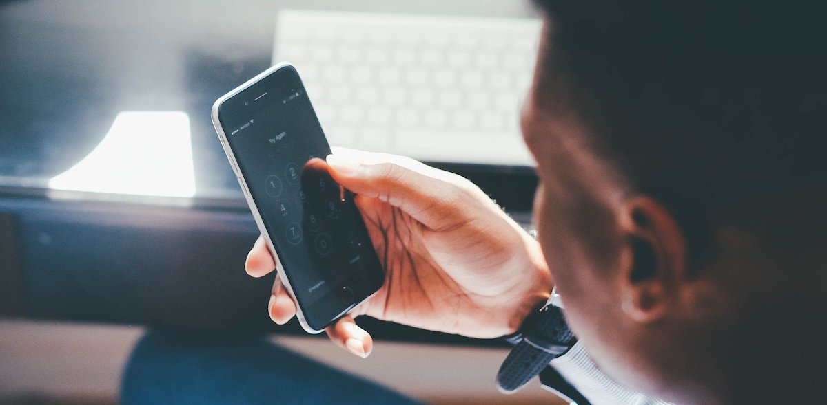 podcasting: image of a man looking at his mobile phone screen