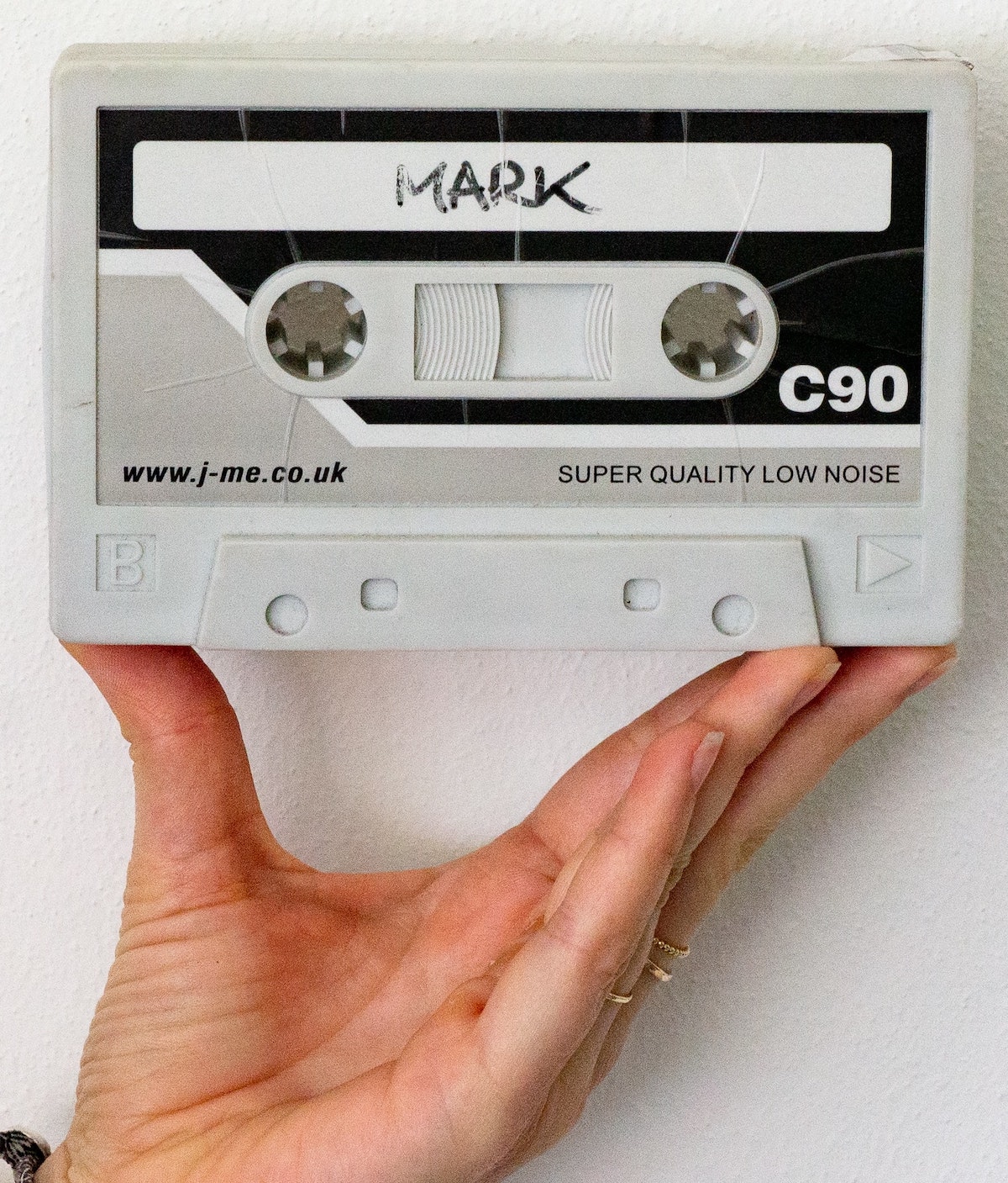 Judging a voice actor's demo: hand holding compact cassette
