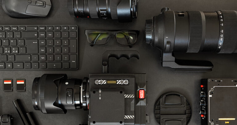 Top View of a Creative Filmmakers Office Desk with Lined up Camera and Gear