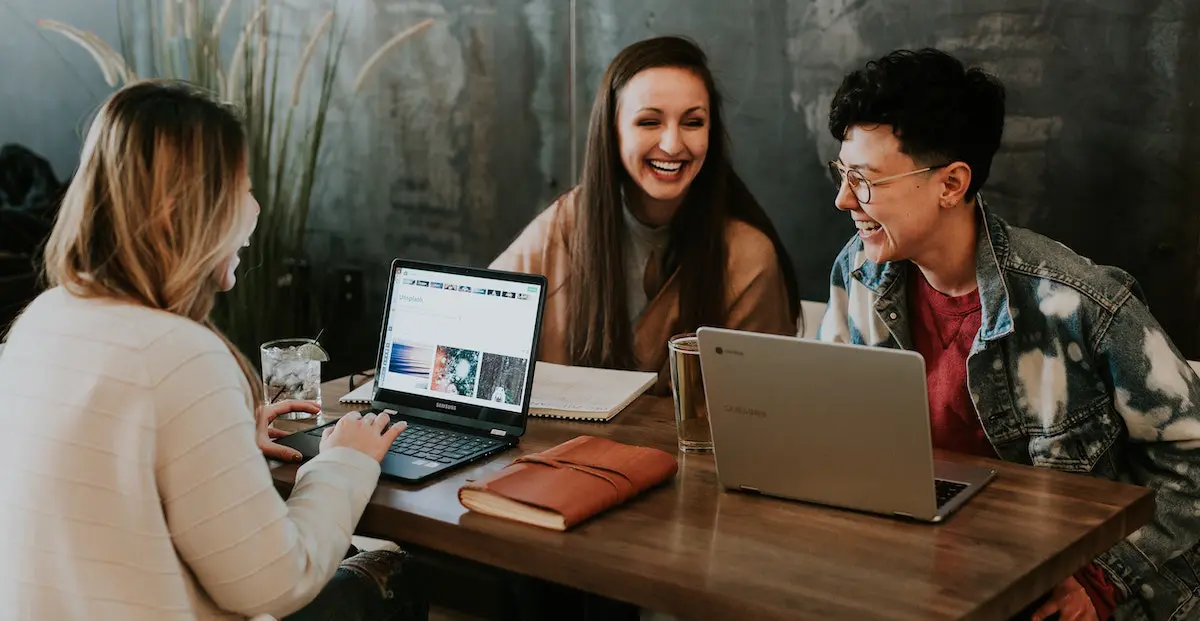 how to start a podcast: three woman planing a podcast at a desk